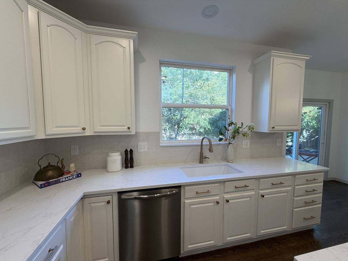 White and gold kitchen remodel in Denver by Gribbons Group Corp